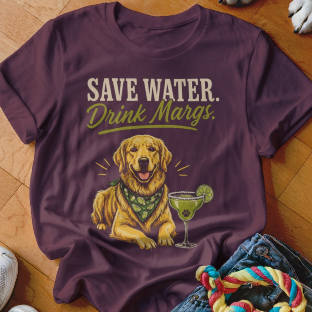 Maroon t-shirt featuring a golden retriever wearing a lime-patterned bandana and a margarita glass, with the text "SAVE WATER. Drink Margs."