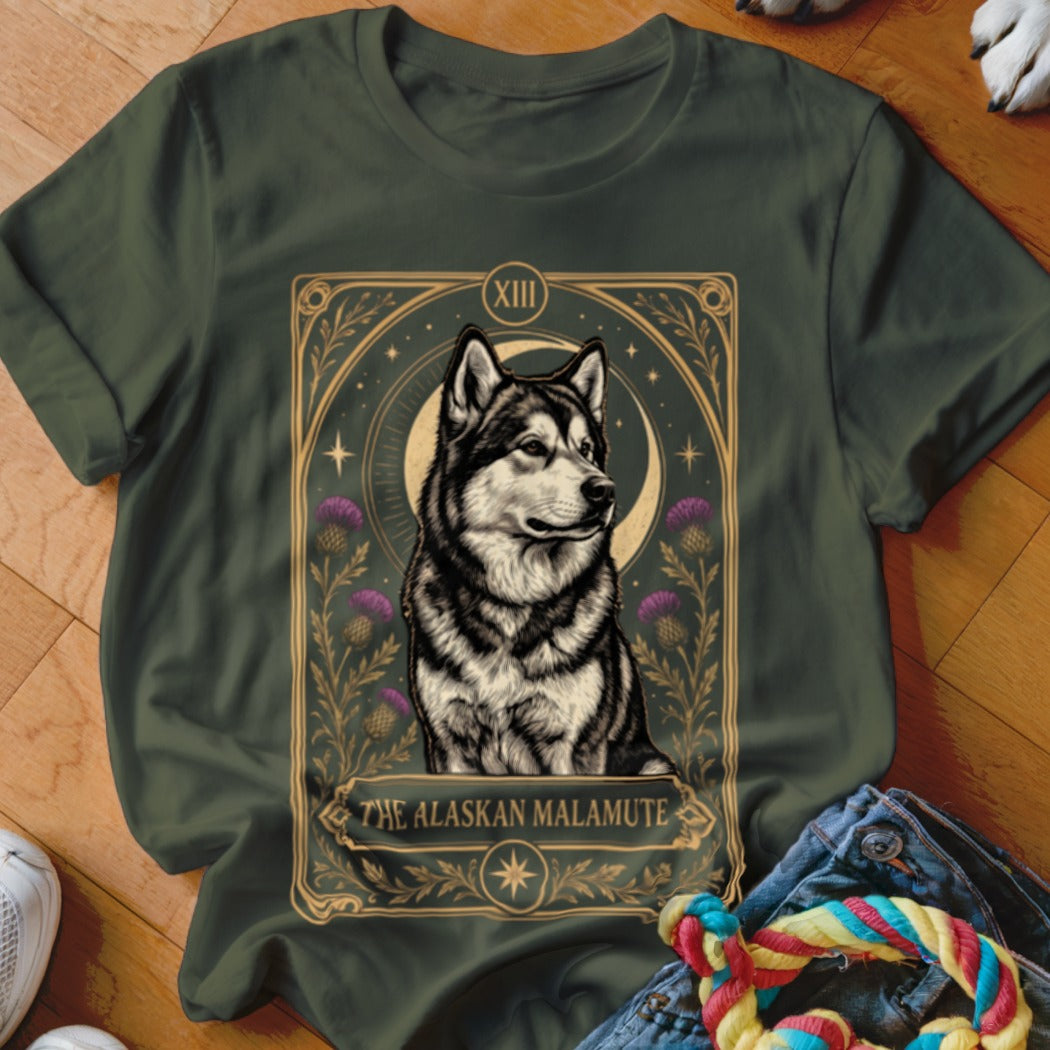 Olive green t-shirt featuring a tarot card graphic of an Alaskan Malamute with purple thistles and a crescent moon.