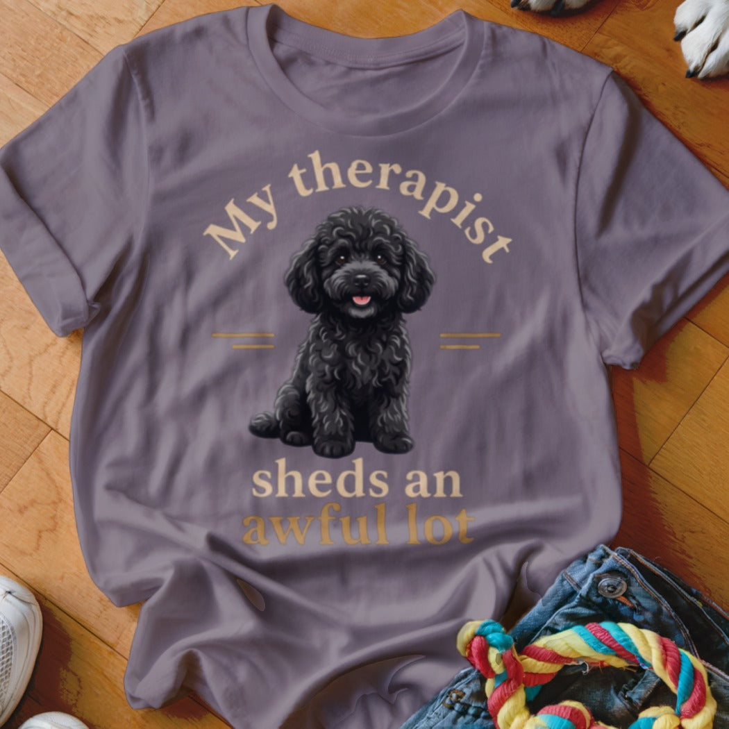T-shirt with a black poodle graphic and text "My therapist sheds an awful lot."