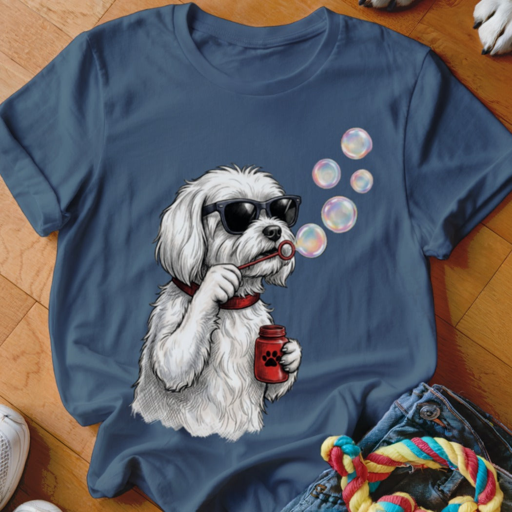Blue crewneck t-shirt featuring a graphic of a white dog wearing sunglasses and blowing soap bubbles.