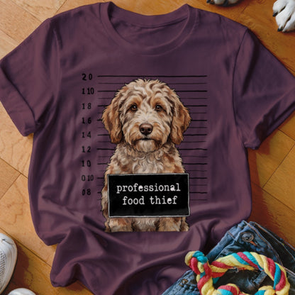 Maroon t-shirt with a Goldendoodle dog mugshot reading "professional food thief".