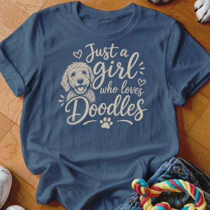 Blue t-shirt with white text and doodle dog graphic reading "Just a girl who loves Doodles."