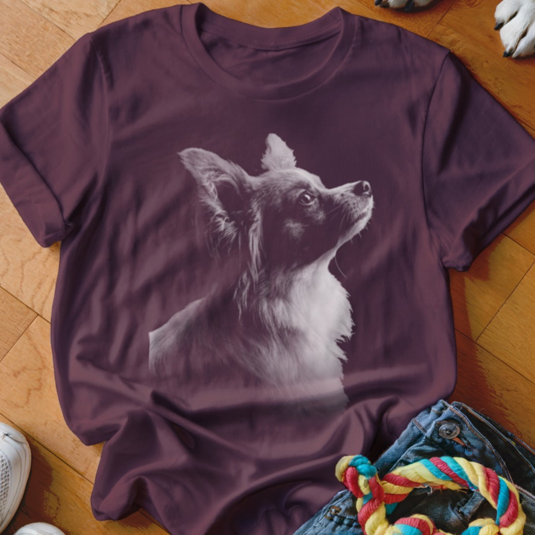 Maroon t-shirt with a grayscale print of a long-haired chihuahua looking up.