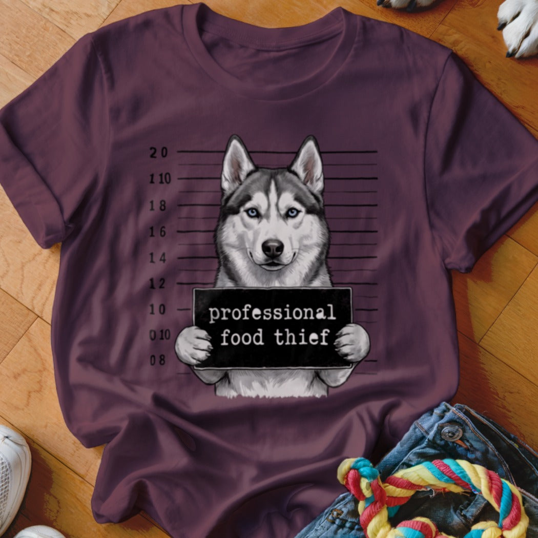 Husky mugshot with sign reading "professional food thief"