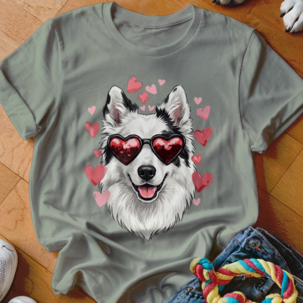 Sage green t-shirt featuring a graphic of a white and black dog wearing heart-shaped sunglasses surrounded by pink hearts.