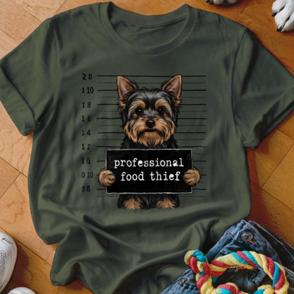 Yorkshire Terrier mugshot with "professional food thief" sign