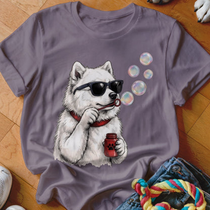 A grey t-shirt featuring a graphic of a white dog wearing sunglasses and blowing bubbles.