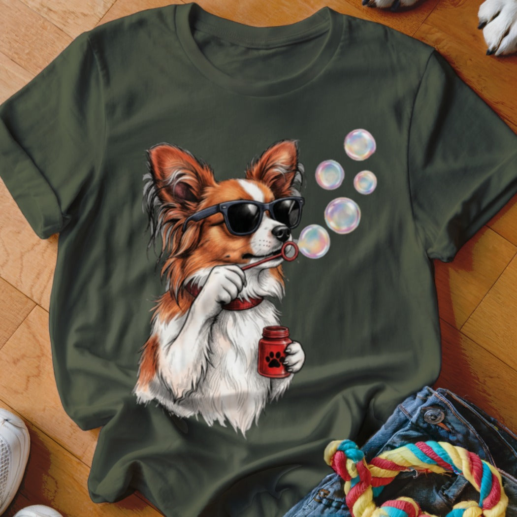 Olive green crewneck t-shirt featuring an illustration of a Papillon dog wearing sunglasses and blowing bubbles.