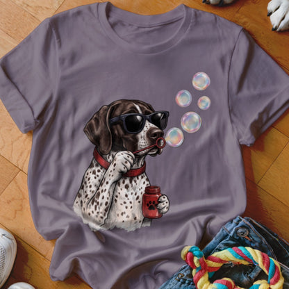 Purple t-shirt featuring a graphic of a spotted dog wearing sunglasses and blowing soap bubbles.