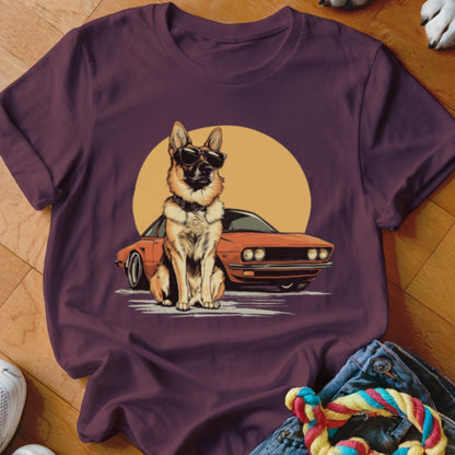 German Shepherd dog wearing sunglasses sitting in front of an orange retro car and sun.