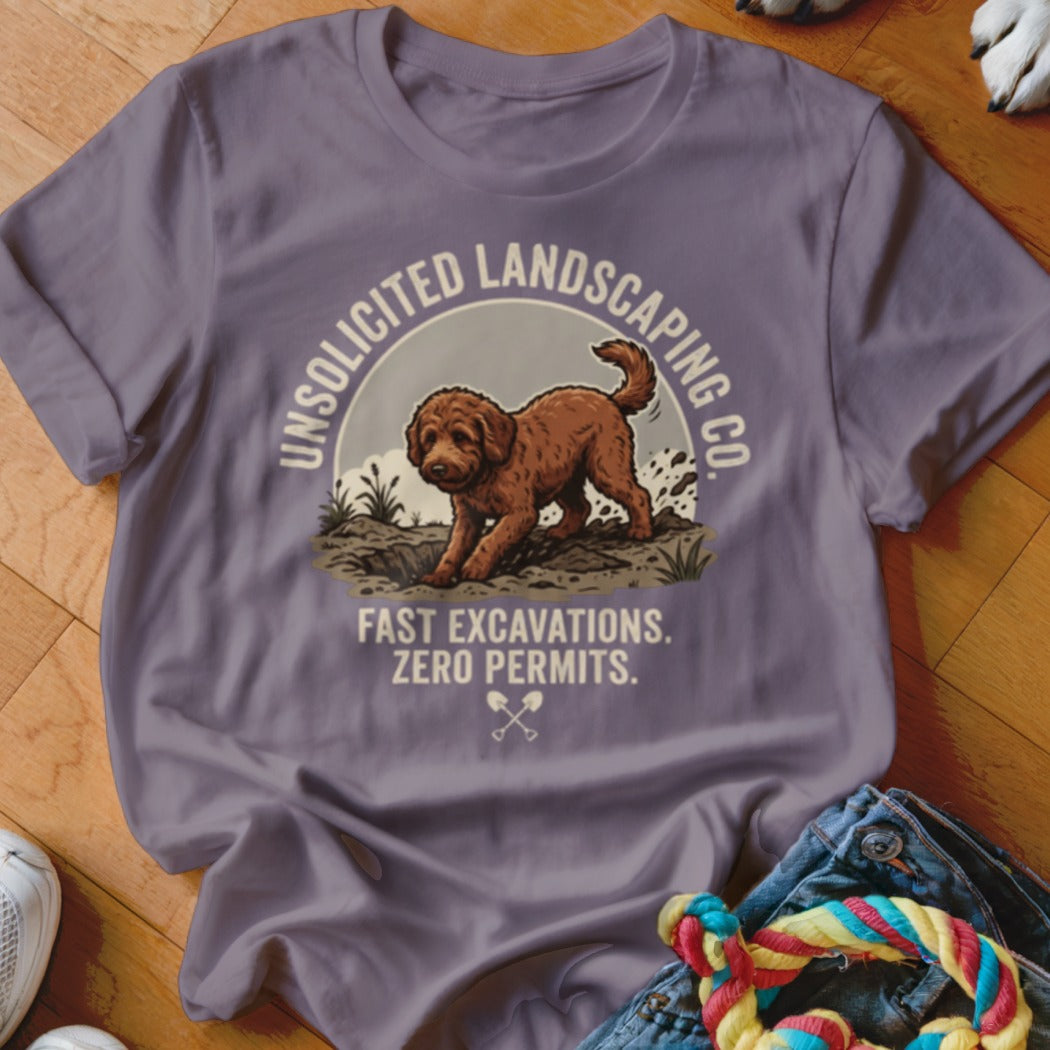 T-shirt graphic: brown dog digging hole, text "UNSOLICITED LANDSCAPING CO. FAST EXCAVATIONS. ZERO PERMITS."