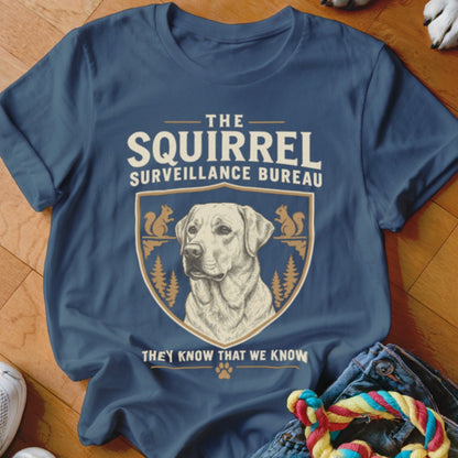 Blue t-shirt featuring a Labrador illustration and the text The Squirrel Surveillance Bureau They Know That We Know.