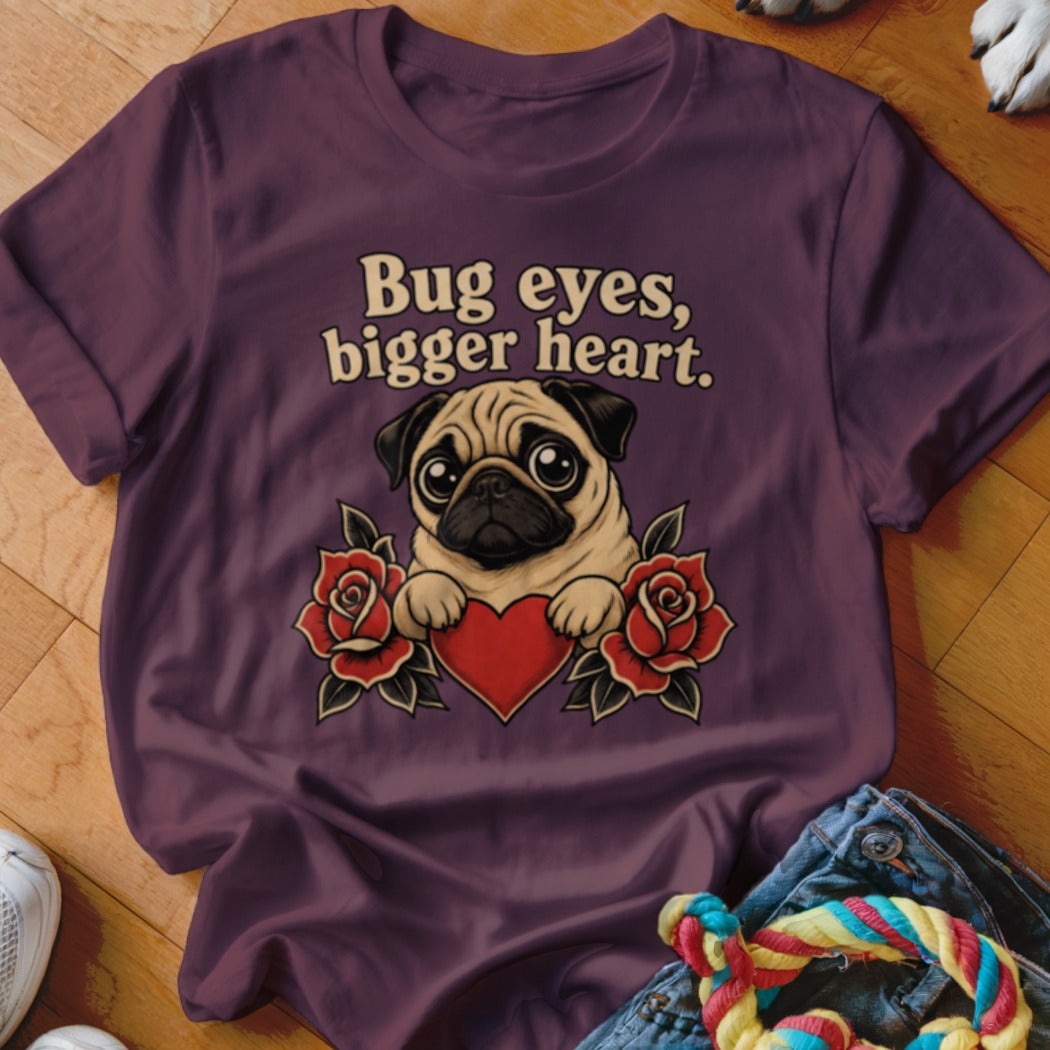 Pug with big eyes and heart surrounded by roses, text "Bug eyes, bigger heart."