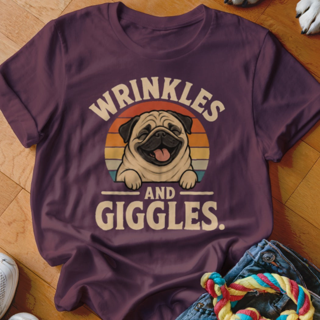 T-shirt with "Wrinkles and Giggles" text and a happy pug in a sunset circle.