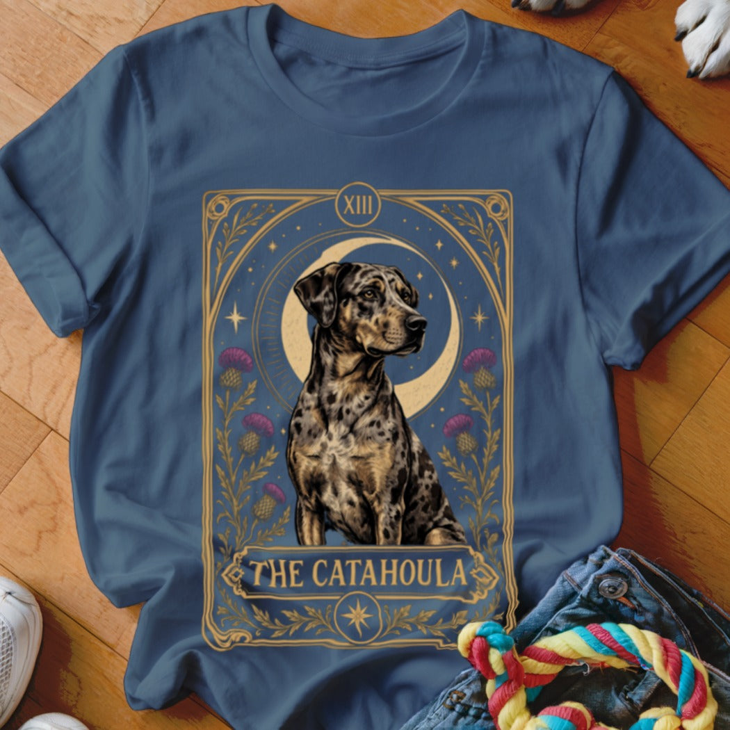 Blue t-shirt featuring a tarot card graphic of a spotted Catahoula dog, crescent moon, and thistles.