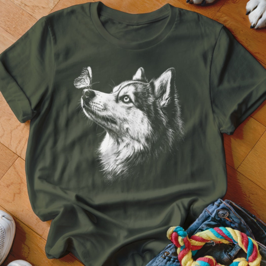 Dark green t-shirt featuring a white sketched graphic of a husky looking at a butterfly.