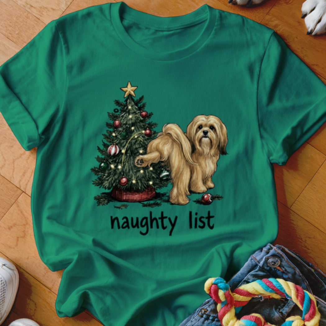 Golden dog lifting leg on Christmas tree with "naughty list" text.