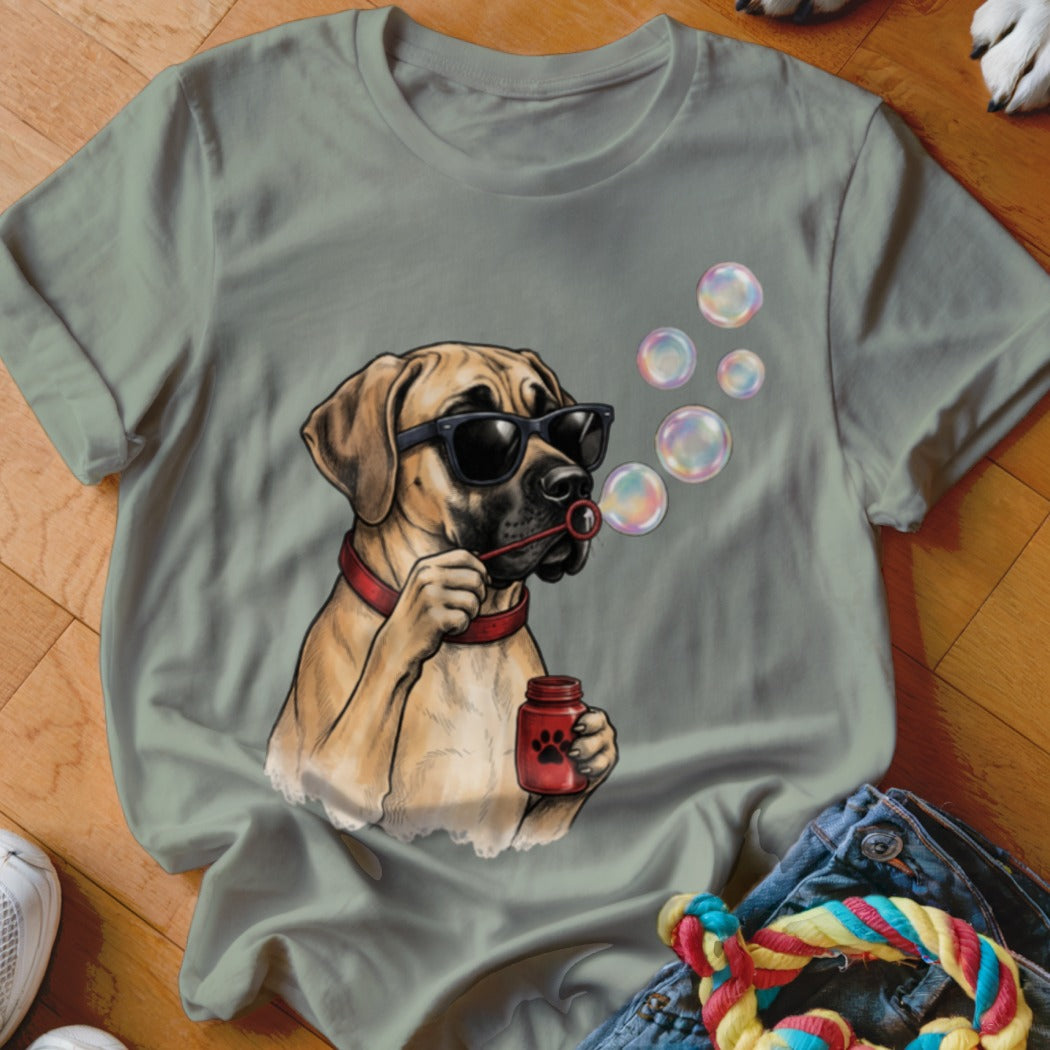 Sage green t-shirt featuring a graphic of a mastiff wearing sunglasses and blowing soap bubbles.