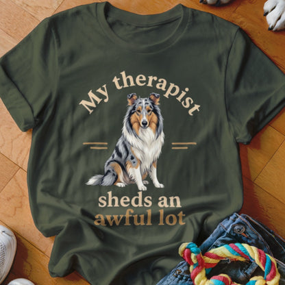 Green t-shirt with dog art and text "My therapist sheds an awful lot".