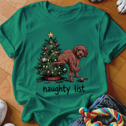 Green t-shirt with a brown dog near a Christmas tree and the text "naughty list".