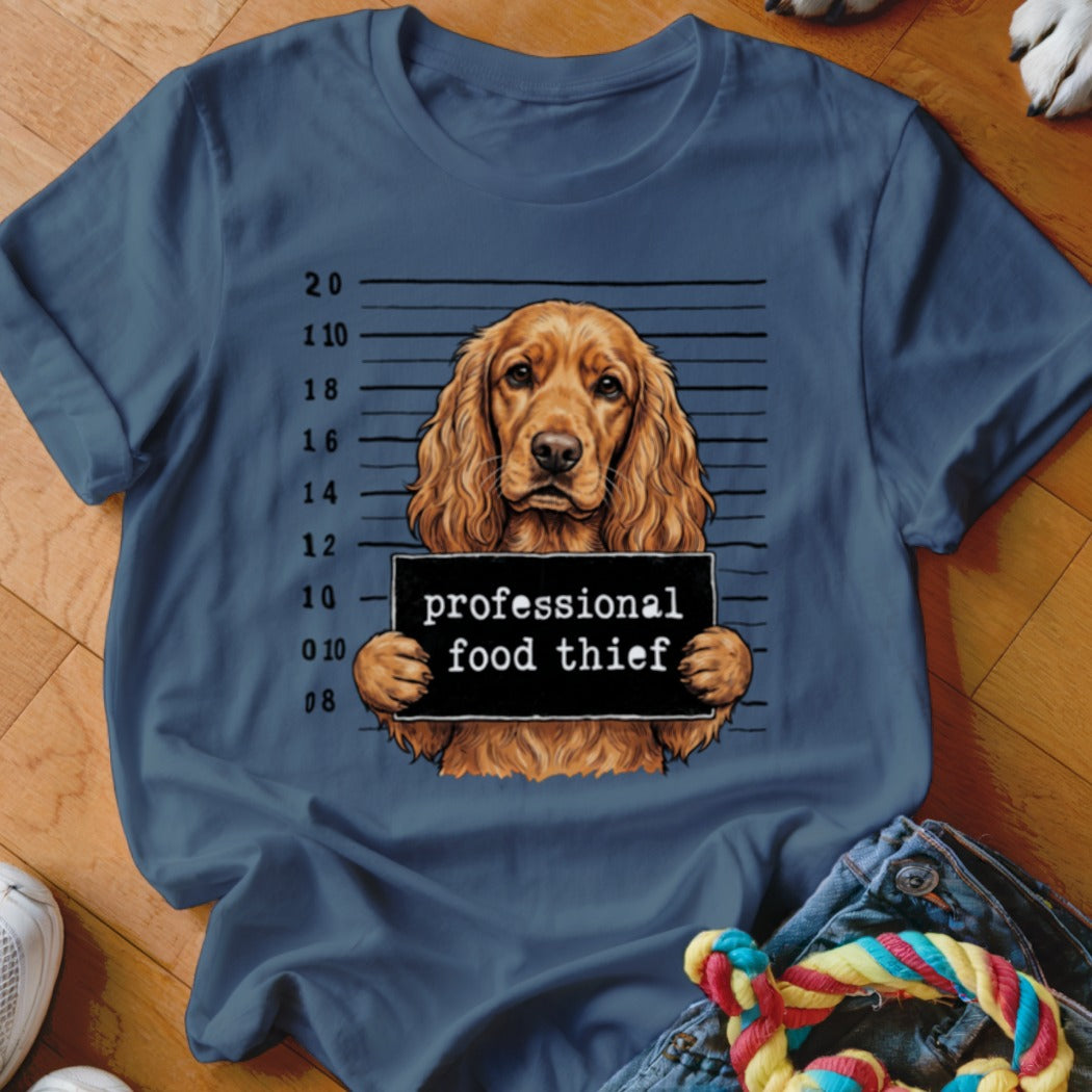 English Cocker Spaniel mugshot with "professional food thief" sign.