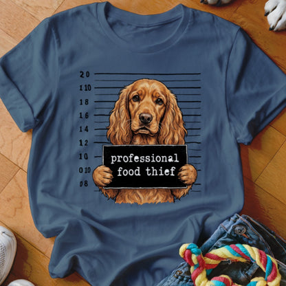 English Cocker Spaniel mugshot with "professional food thief" sign.