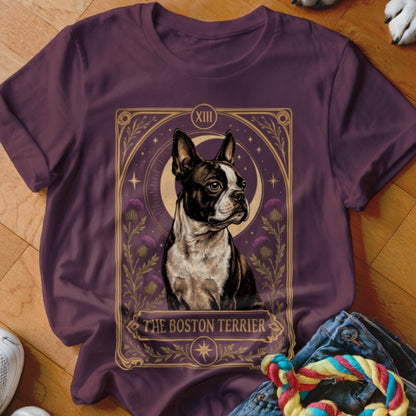 A dark purple t-shirt featuring a tarot card design centered with a Boston Terrier illustration.