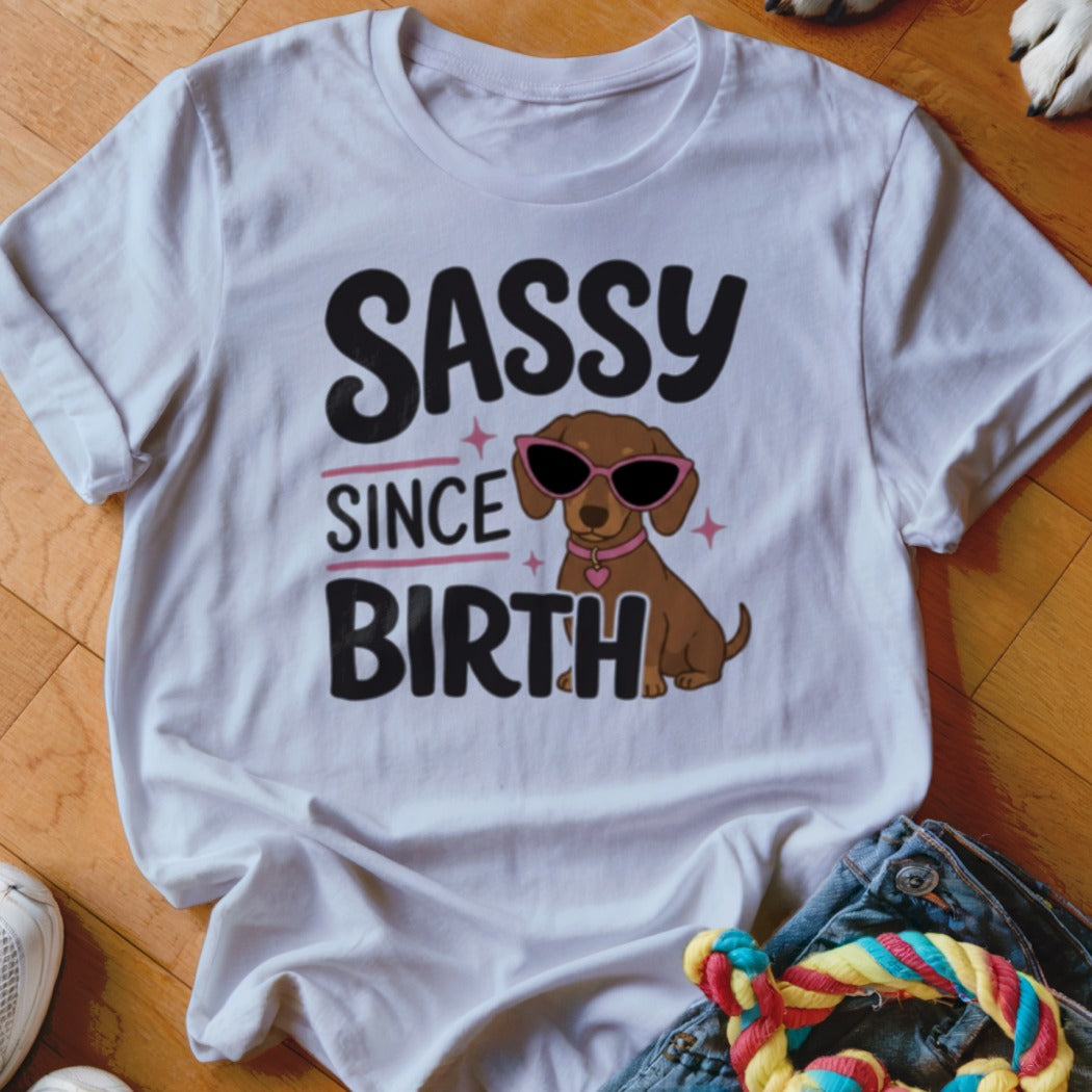 White t-shirt with "Sassy Since Birth" text and sunglasses-wearing dachshund graphic.