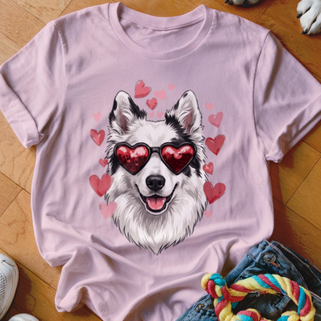 Light pink t-shirt featuring a graphic of a white and black dog wearing heart-shaped sunglasses surrounded by pink hearts.