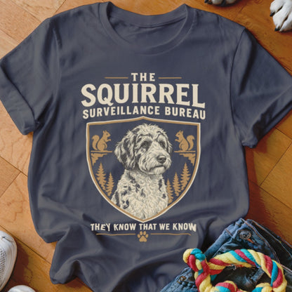 Dark gray t-shirt featuring a crest with a doodle dog, pine trees, squirrels, and text.