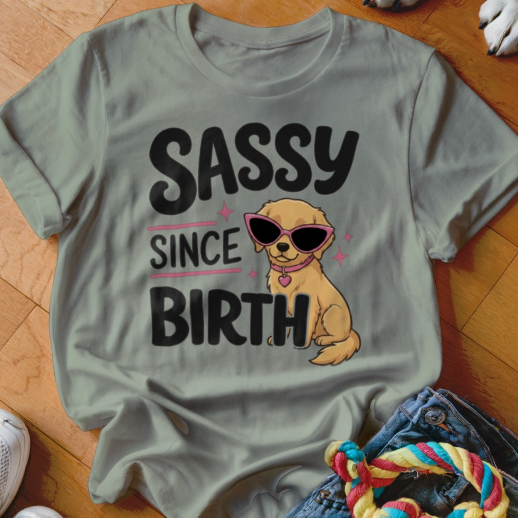 Golden retriever puppy wearing pink sunglasses with "SASSY SINCE BIRTH" text.