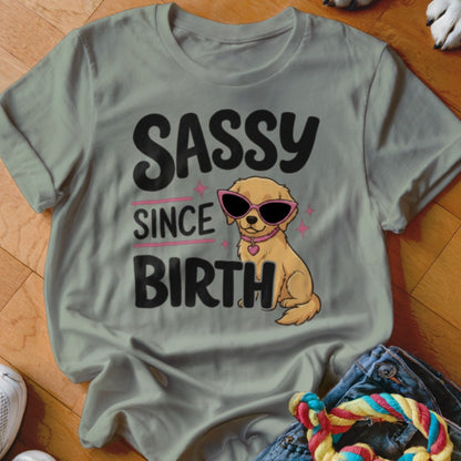 Golden retriever puppy wearing pink sunglasses with "SASSY SINCE BIRTH" text.