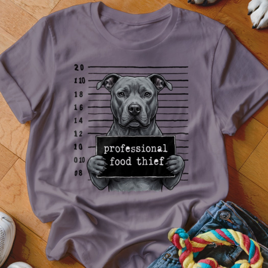 Pit bull mugshot on t-shirt reads "professional food thief".
