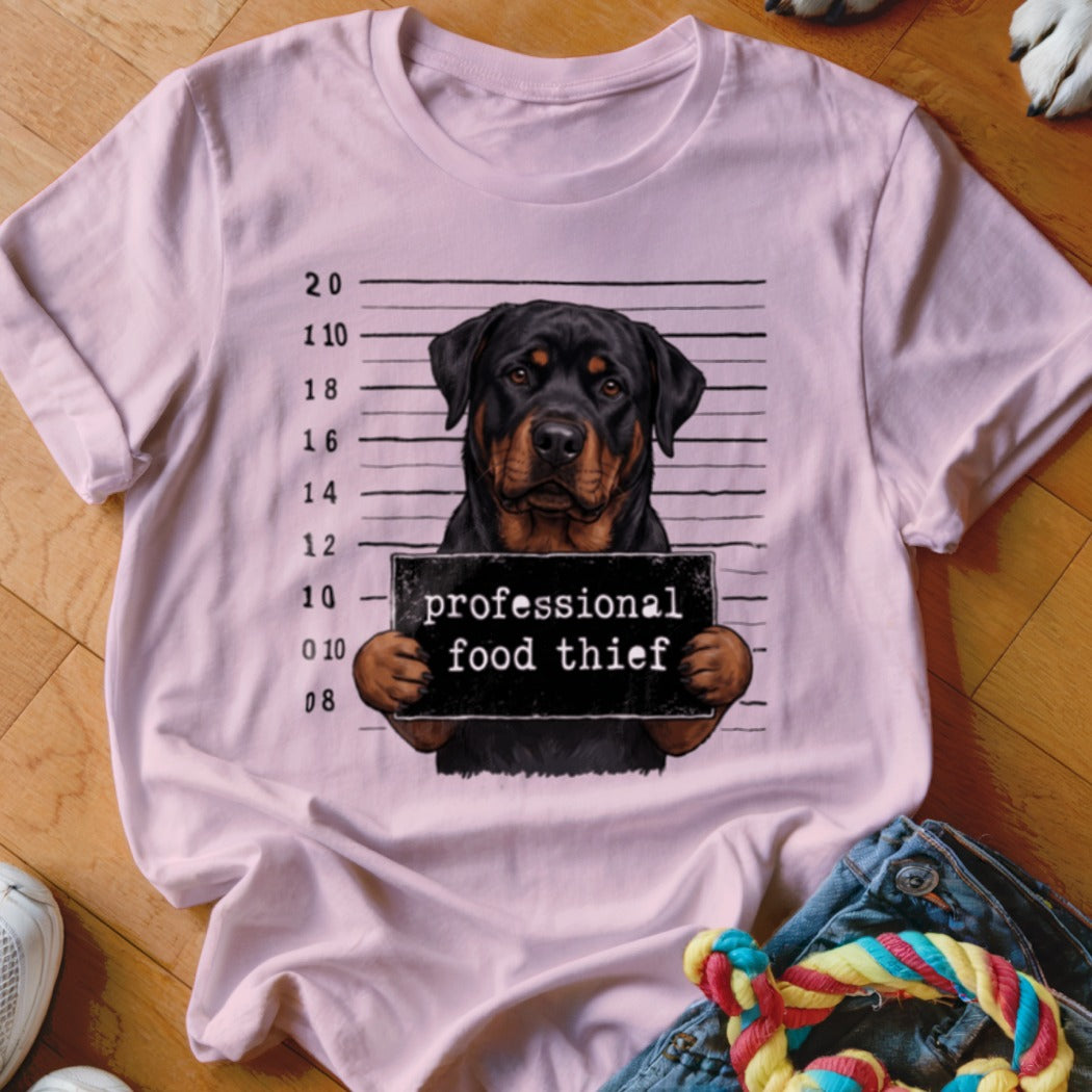 Rottweiler mugshot with sign reading "professional food thief."