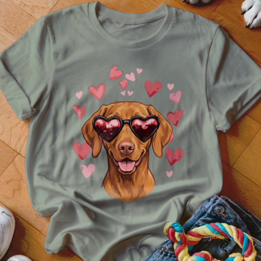 Sage green t-shirt featuring a brown dog wearing heart-shaped sunglasses, surrounded by pink hearts.
