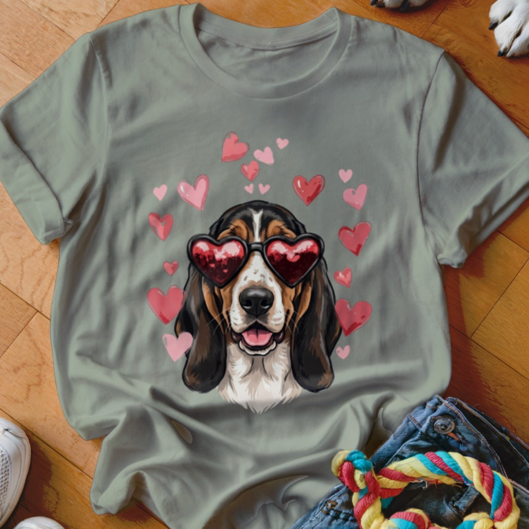 Sage green t-shirt featuring a basset hound wearing heart sunglasses surrounded by pink hearts.