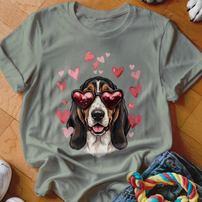 Sage green t-shirt featuring a basset hound wearing heart sunglasses surrounded by pink hearts.