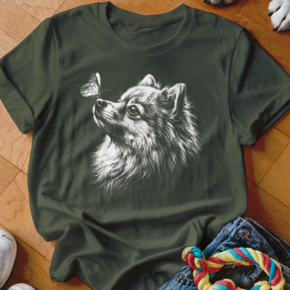 Dark green t-shirt featuring a white sketch of a Pomeranian dog looking at a butterfly on its nose.
