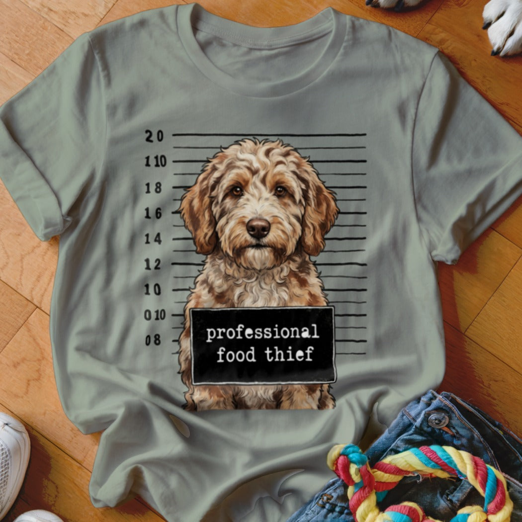 Dog with mugshot sign that says "professional food thief".