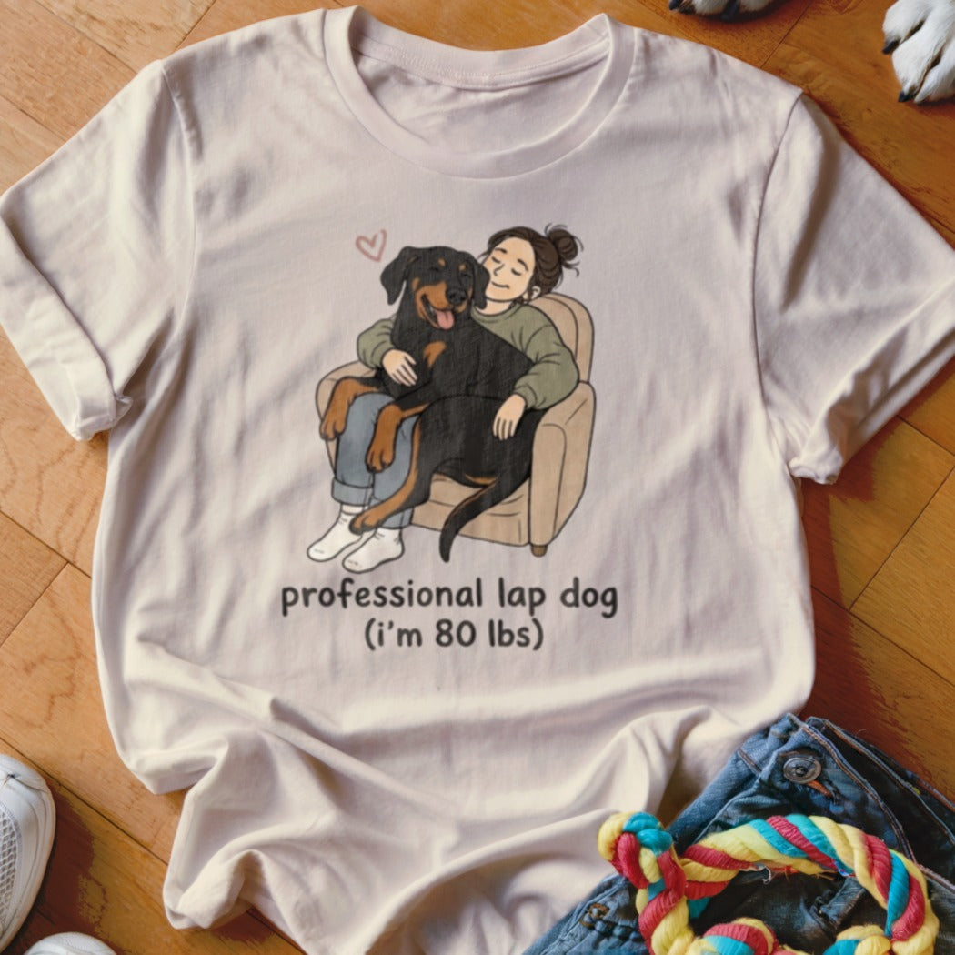 Illustration on a t-shirt shows a woman hugging a Rottweiler, with text "professional lap dog (i'm 80 lbs)".