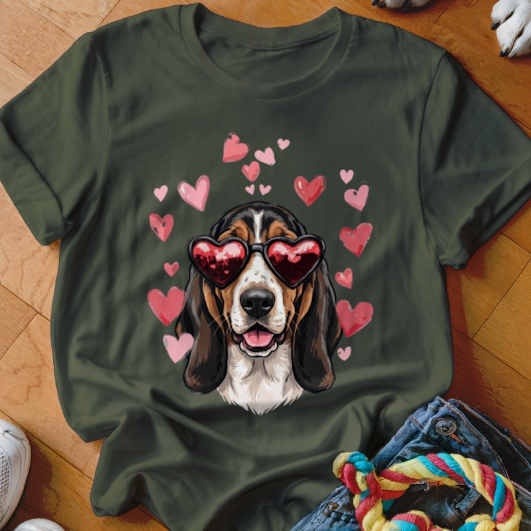 Dark green t-shirt featuring a basset hound wearing heart-shaped sunglasses surrounded by pink hearts.