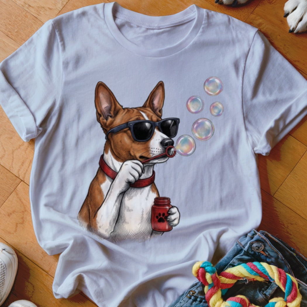 A white t-shirt featuring an illustration of a brown and white dog wearing sunglasses and blowing bubbles.