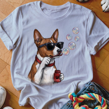 A white t-shirt featuring an illustration of a brown and white dog wearing sunglasses and blowing bubbles.