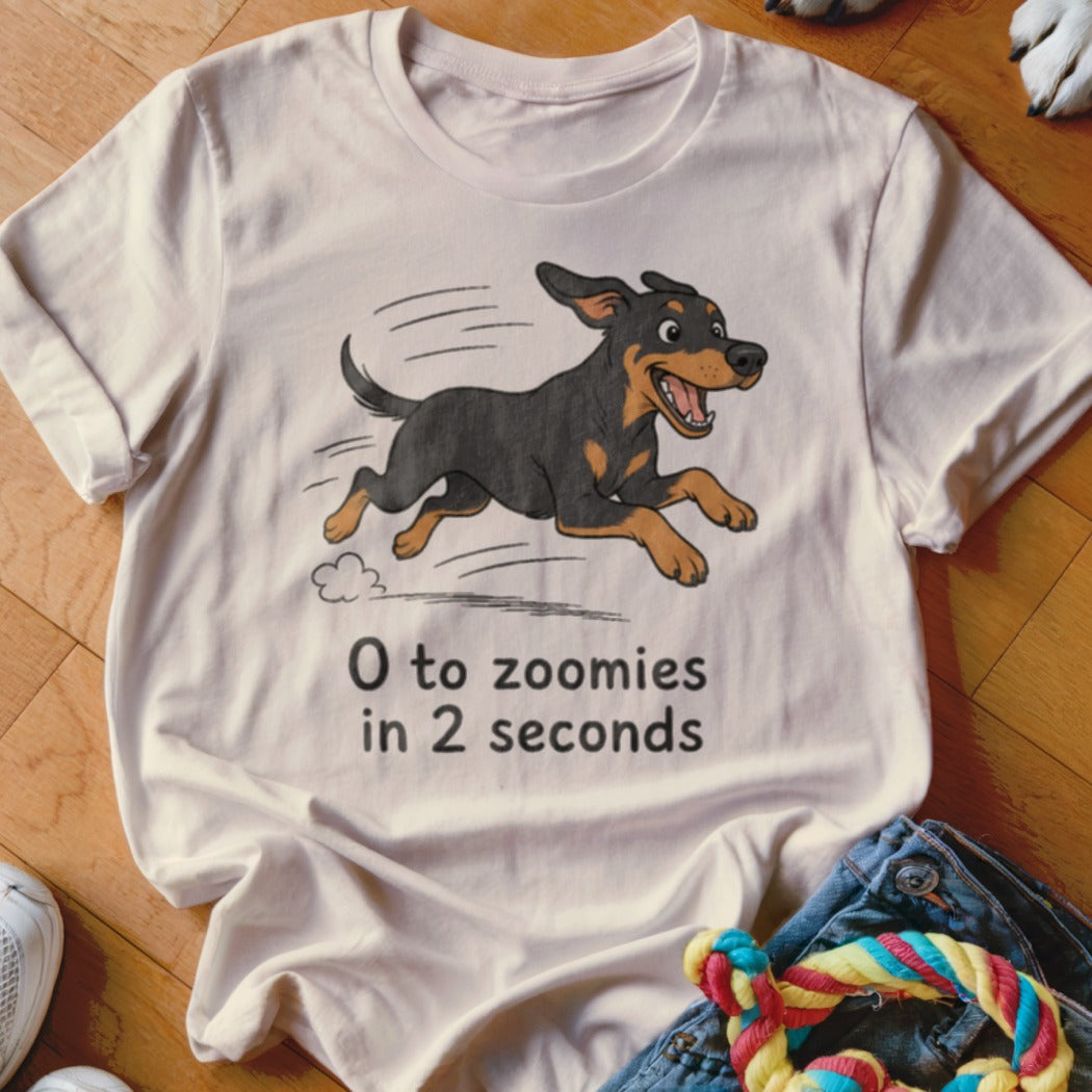 White t-shirt with cartoon dog running and text "0 to zoomies in 2 seconds".