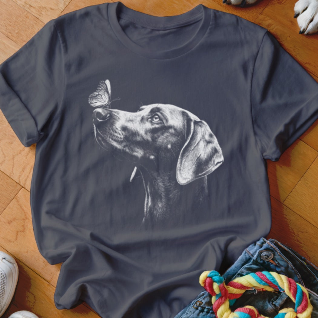 A dark gray crewneck t-shirt featuring a white sketch graphic of a dog looking at a butterfly.