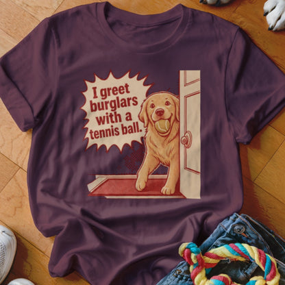 Golden retriever holding a tennis ball in a doorway with text that says "I greet burglars with a tennis ball."