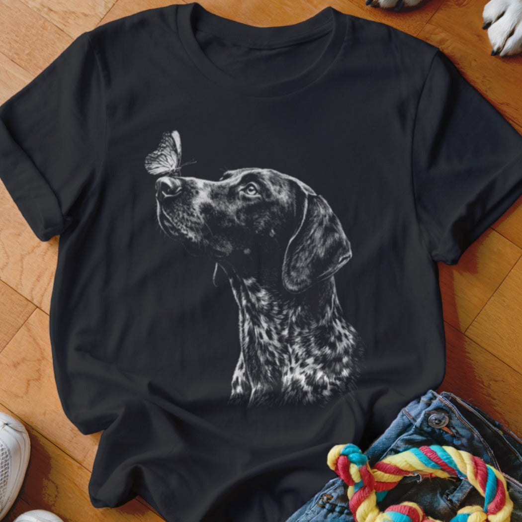 A black t-shirt features a white graphic of a pointer dog looking at a butterfly.