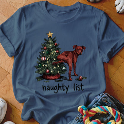 Brown dog pees on a Christmas tree with text "naughty list".