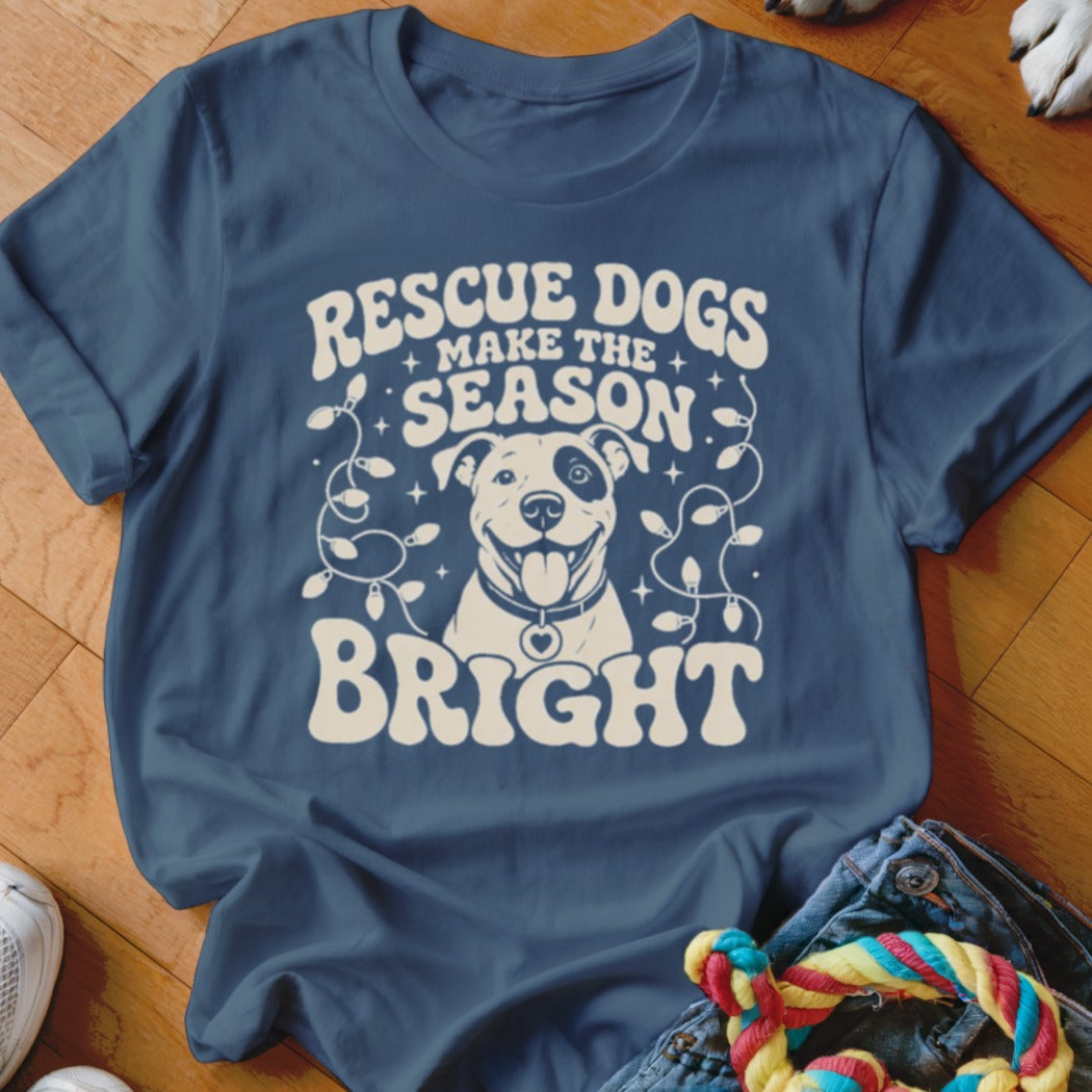 Blue t-shirt with white text "RESCUE DOGS MAKE THE SEASON BRIGHT" and a dog illustration.