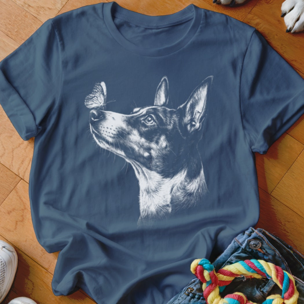 A blue crewneck t-shirt featuring a white sketch graphic of a dog looking at a butterfly.